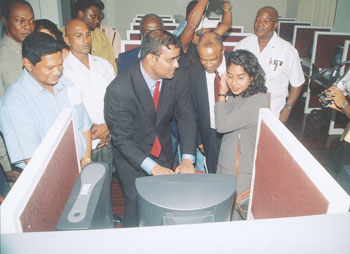  President Bharrat Jagdeo; US Ambassador, Mr. Roland Bullen and Chief Executive Officer of GT&T, Ms. Sonita Jagan trying-out one of the internet-ready computers in the IT facility.