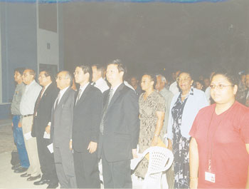 A section of the gathering singing the National Anthem during Friday nights ceremony to open the spanking new Information Technology Centre at UG.